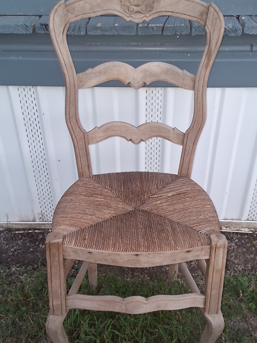 vintage French Provincial or Louis XV-style ladder-back chair with a woven rush